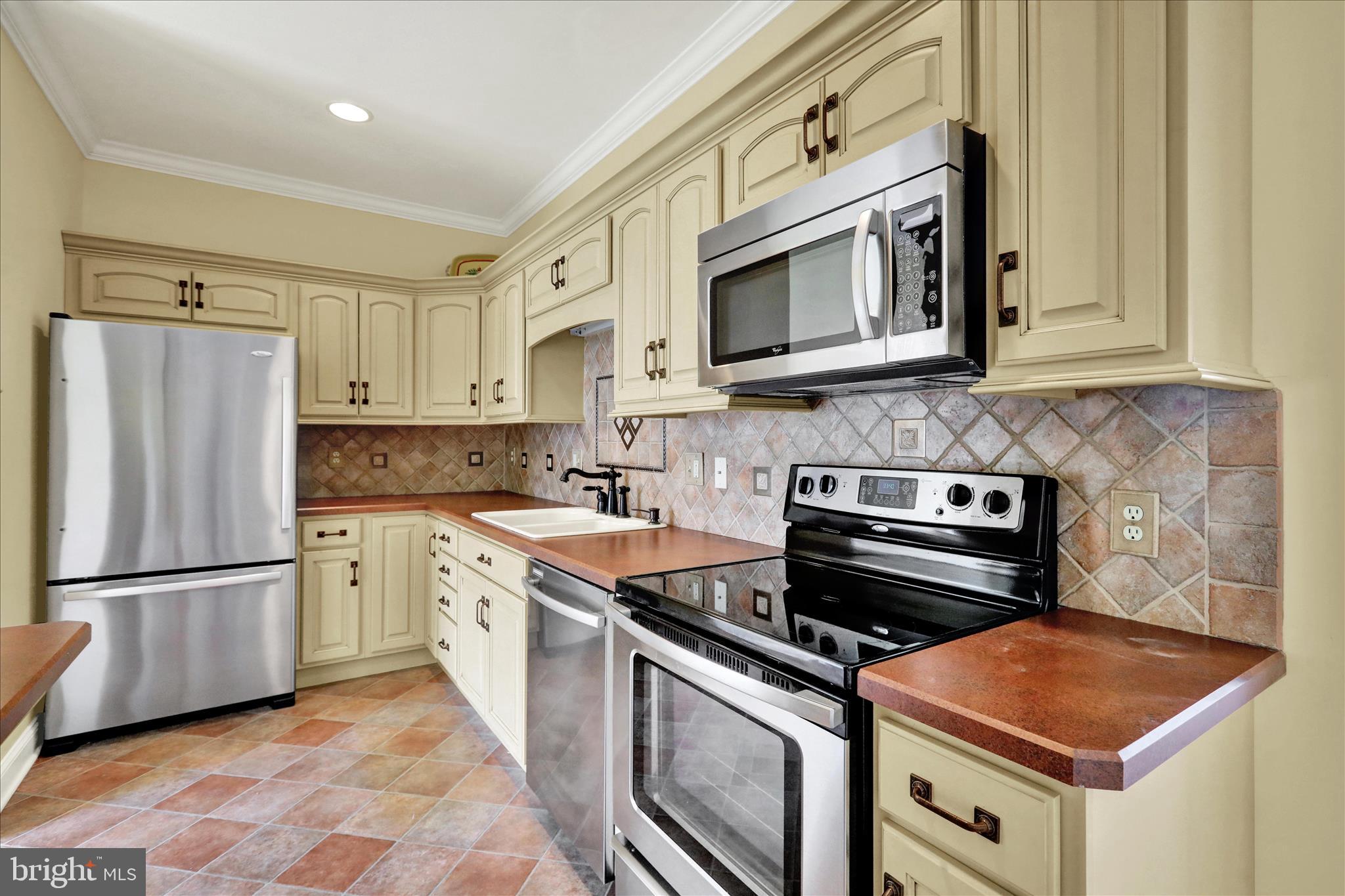 1000 Bluestone Drive Lititz, PA 17543 - Photo 73 of 132 a kitchen with stainless steel appliances granite countertop a stove a refrigerator and a microwave
