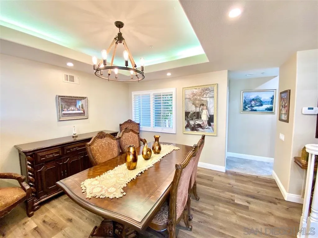 1988 Monarch Ridge Circle El Cajon, CA 92019 - Photo 12 of 27 a dining room with wooden floor a chandelier a wooden table and chairs