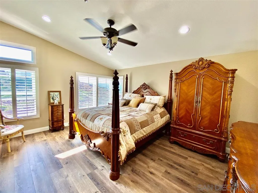 1988 Monarch Ridge Circle El Cajon, CA 92019 - Photo 13 of 27 a bedroom with a bed and wooden floor