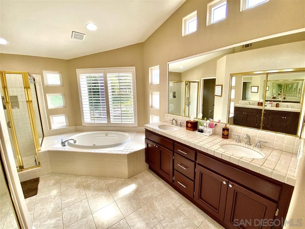 1988 Monarch Ridge Circle El Cajon, CA 92019 - Photo 14 of 27 a spacious bathroom with a tub double sink and mirror