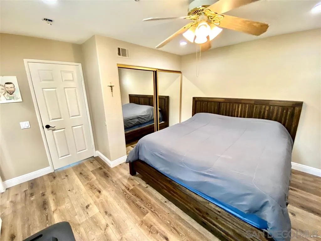 1988 Monarch Ridge Circle El Cajon, CA 92019 - Photo 15 of 27 a bedroom with a large bed and a chandelier