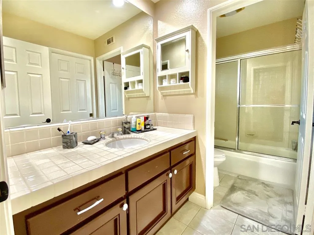 1988 Monarch Ridge Circle El Cajon, CA 92019 - Photo 16 of 27 a bathroom with a granite countertop sink and a mirror