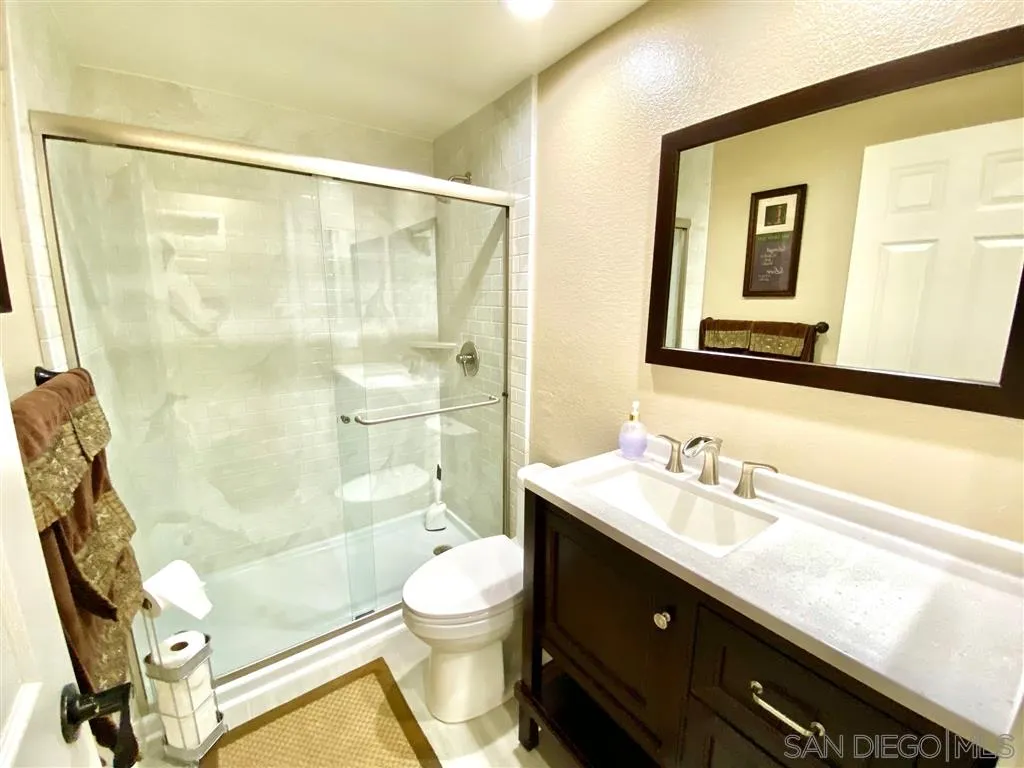 1988 Monarch Ridge Circle El Cajon, CA 92019 - Photo 18 of 27 a bathroom with a sink mirror vanity shower and a toilet