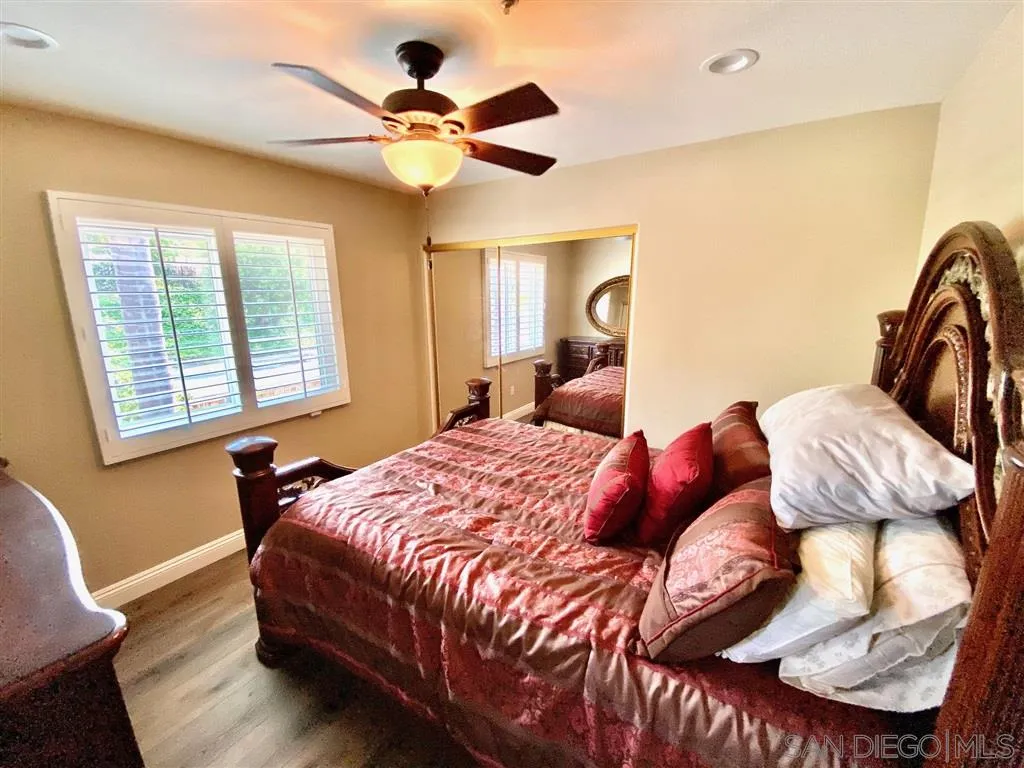 1988 Monarch Ridge Circle El Cajon, CA 92019 - Photo 19 of 27 a bedroom with a bed and wooden floor