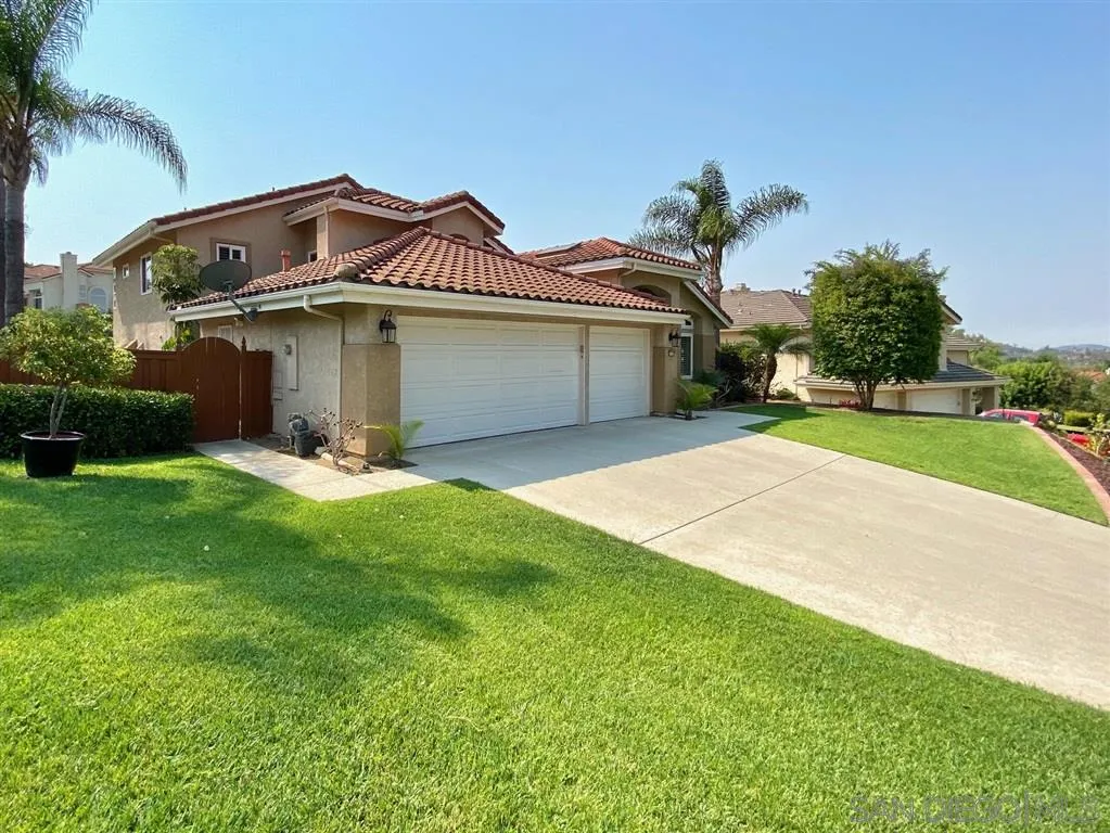 1988 Monarch Ridge Circle El Cajon, CA 92019 - Photo 2 of 27 a front view of a house with a yard and garage