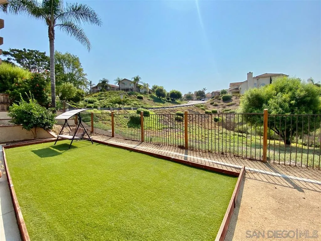 1988 Monarch Ridge Circle El Cajon, CA 92019 - Photo 22 of 27 a view of a swimming pool with a patio and a yard