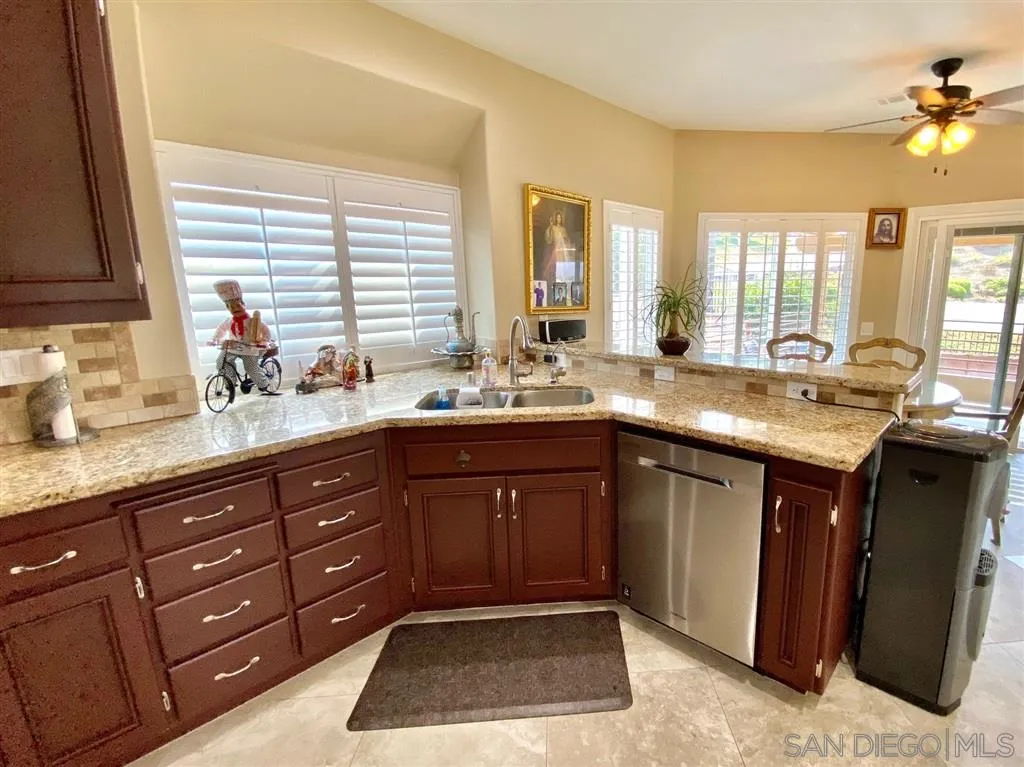 1988 Monarch Ridge Circle El Cajon, CA 92019 - Photo 5 of 27 a spacious bathroom with a granite countertop double vanity and a large mirror