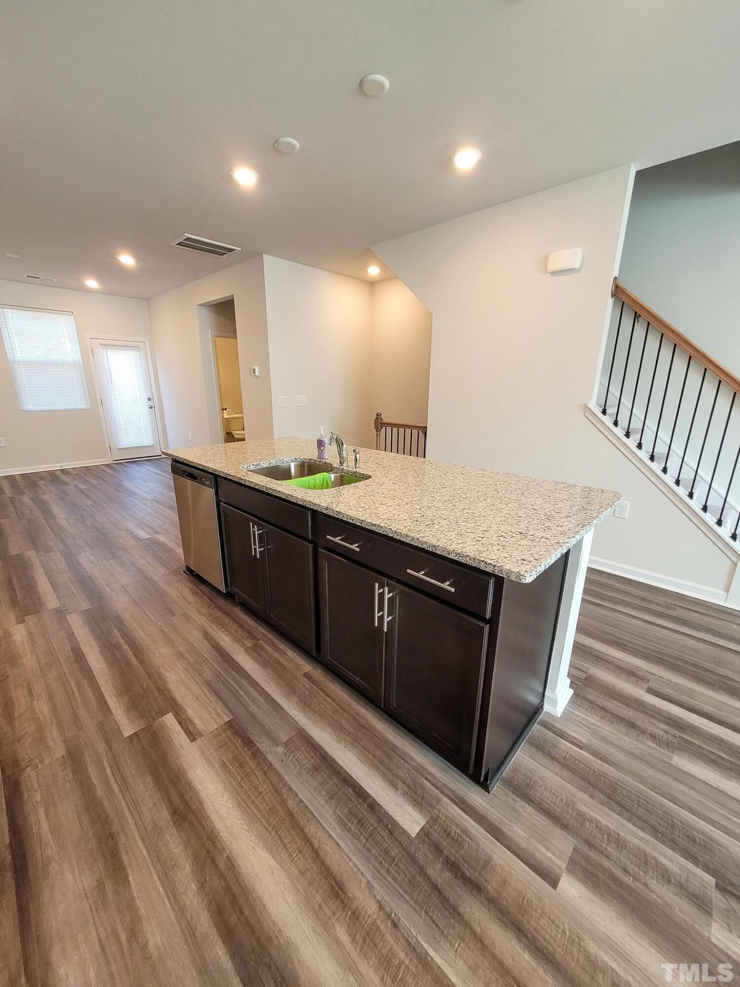 1038 Shoreside Drive Durham, NC 27713 - Photo 16 of 42 a spacious bathroom with a granite countertop sink a mirror and a toilet