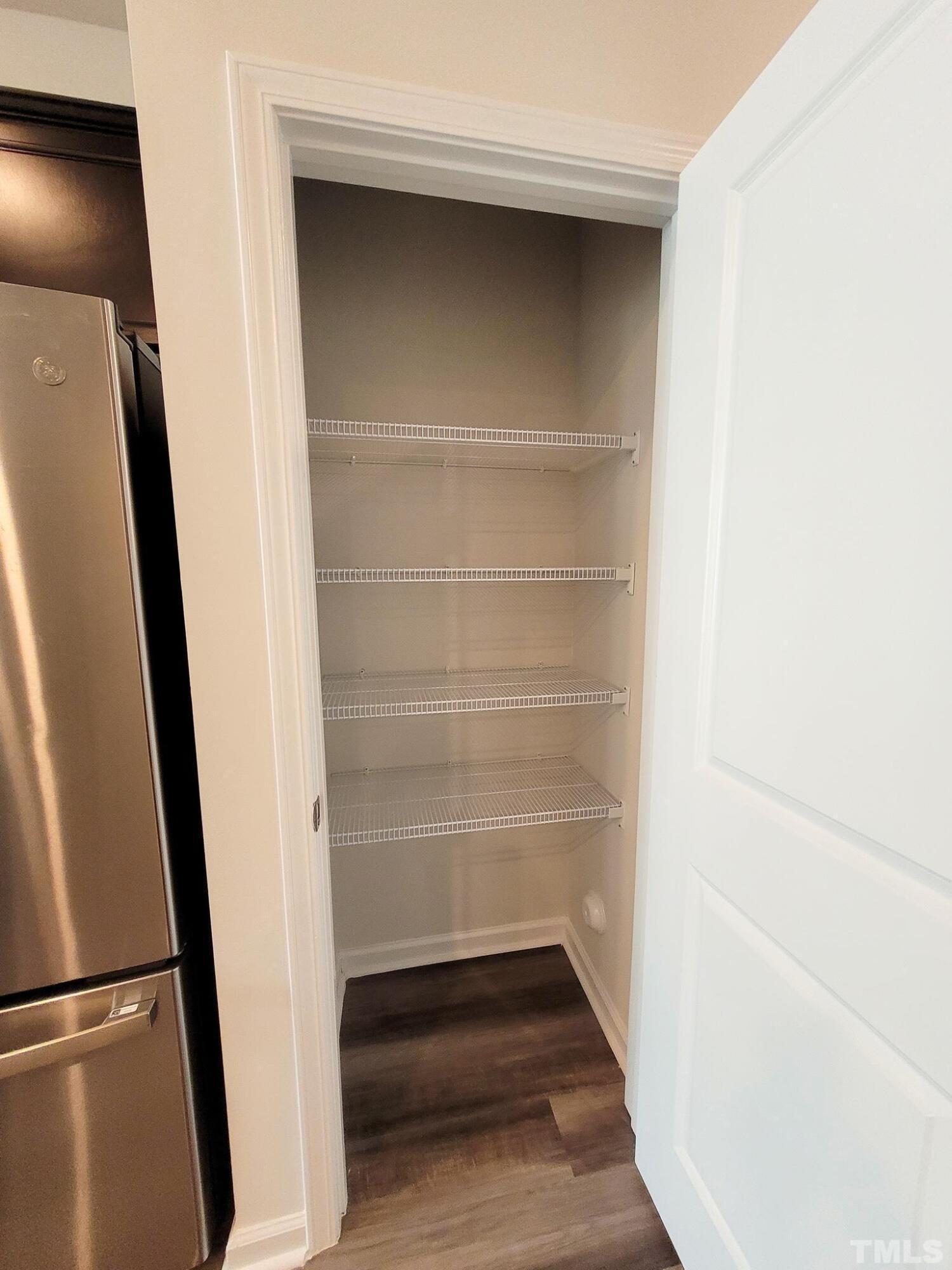 1038 Shoreside Drive Durham, NC 27713 - Photo 17 of 42 a view of walk in closet with empty racks
