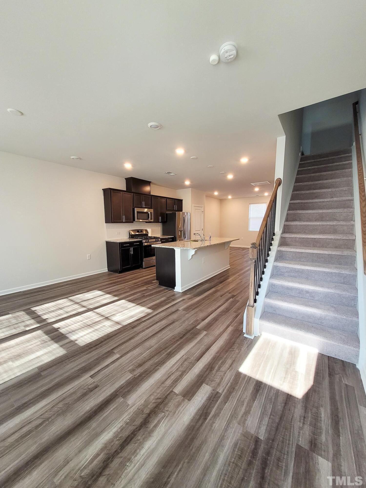 1038 Shoreside Drive Durham, NC 27713 - Photo 21 of 42 a view of kitchen and hall with wooden floor