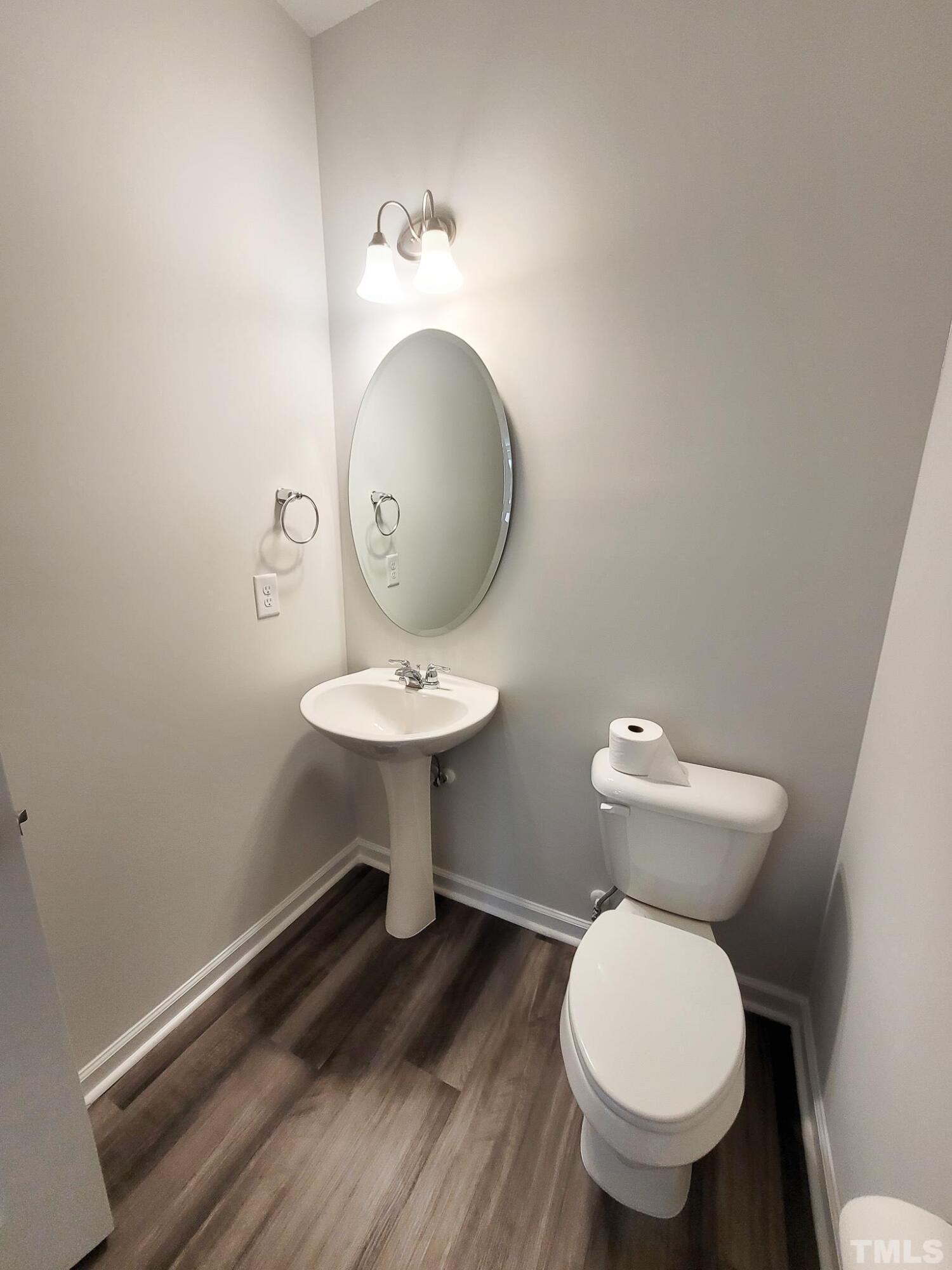 1038 Shoreside Drive Durham, NC 27713 - Photo 22 of 42 a bathroom with a toilet sink and mirror