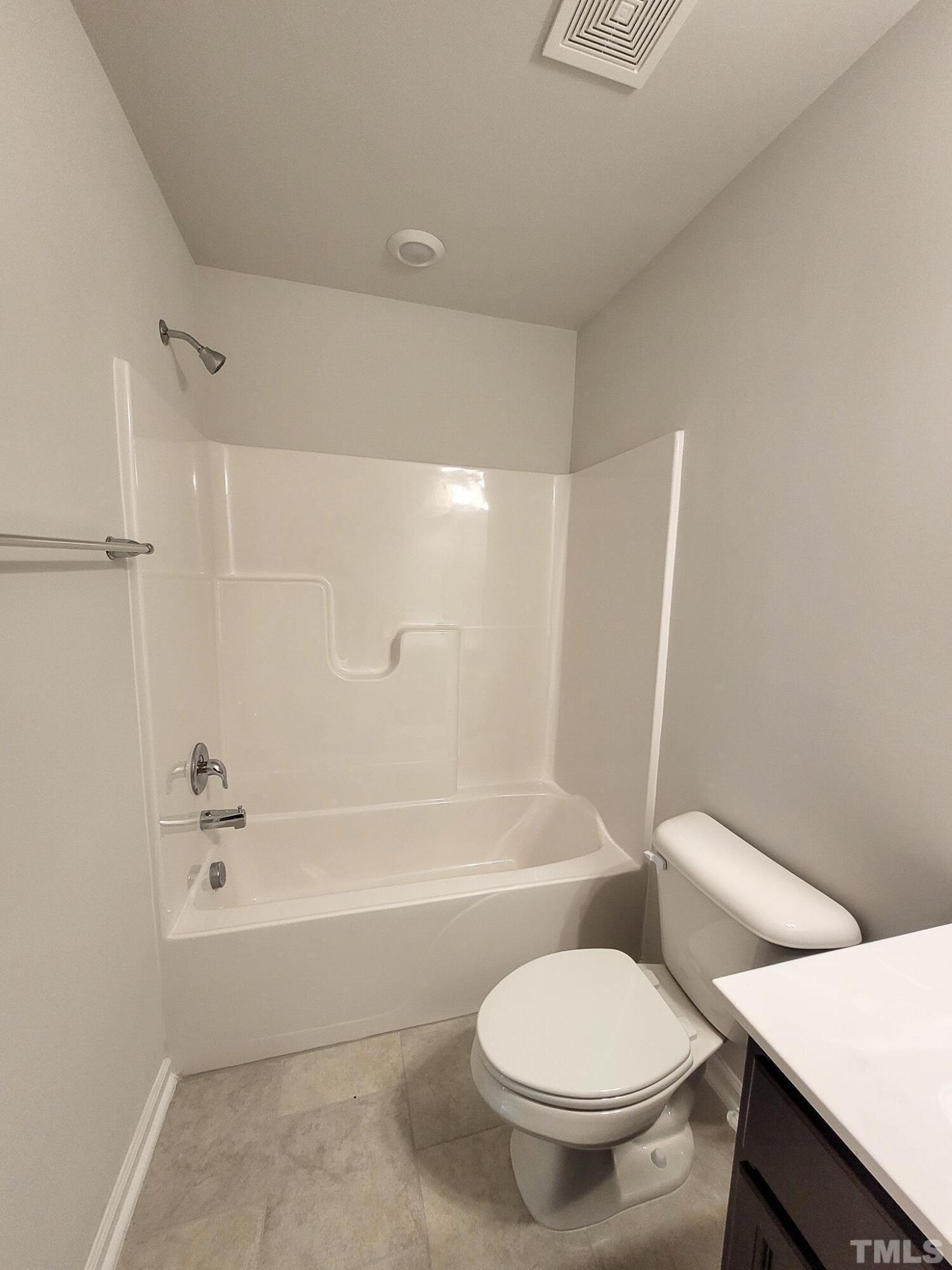 1038 Shoreside Drive Durham, NC 27713 - Photo 29 of 42 a white toilet sitting next to a bath tub