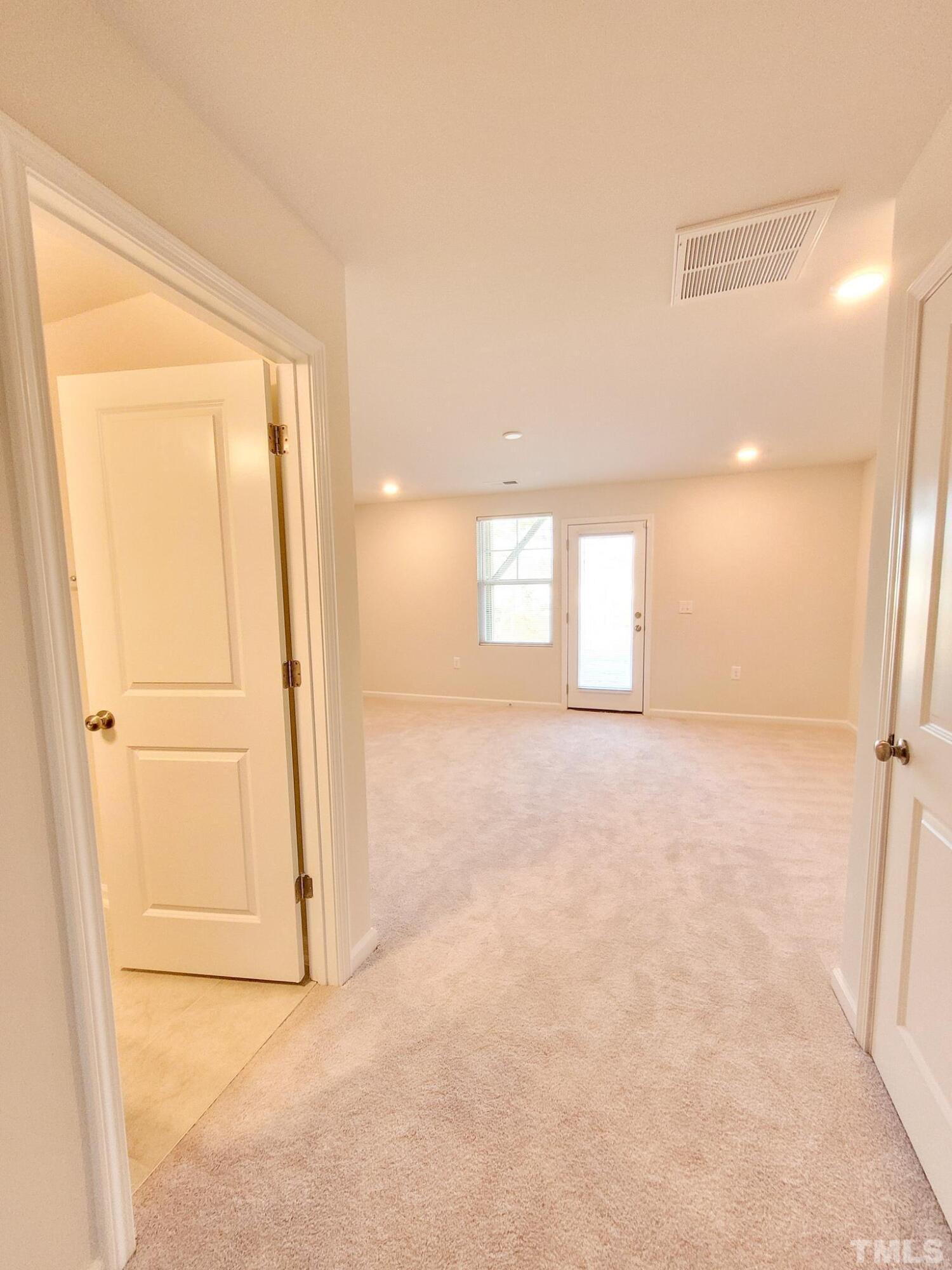 1038 Shoreside Drive Durham, NC 27713 - Photo 3 of 42 an empty room with windows and closet