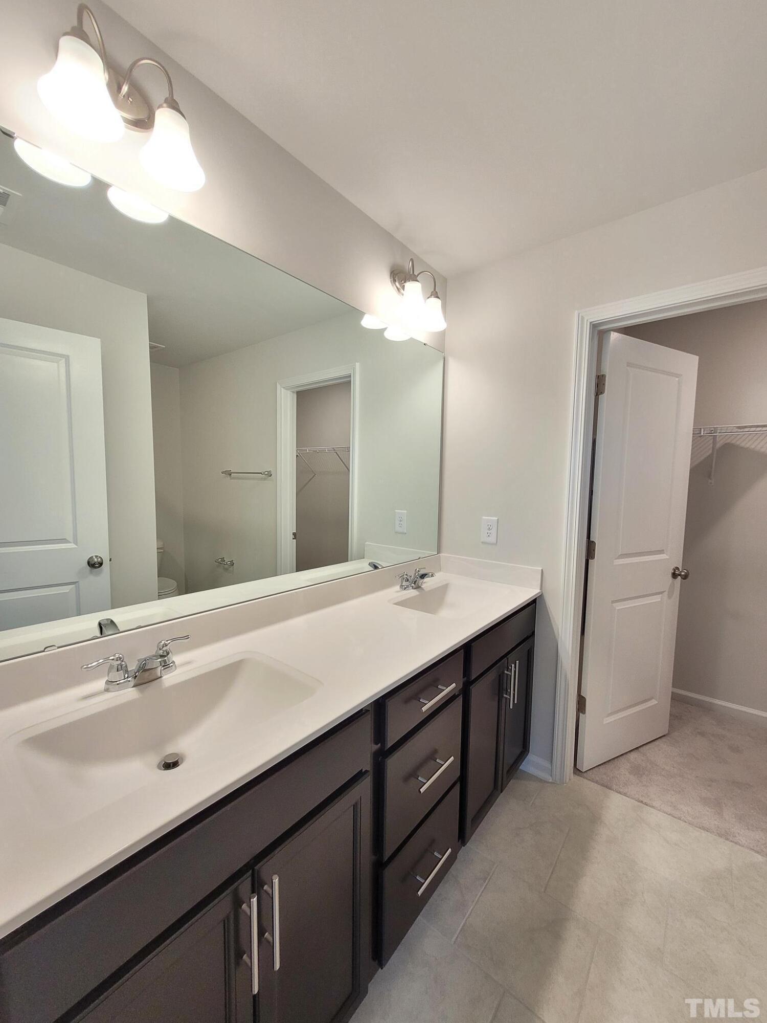 1038 Shoreside Drive Durham, NC 27713 - Photo 35 of 42 a bathroom with a double vanity sink and mirror
