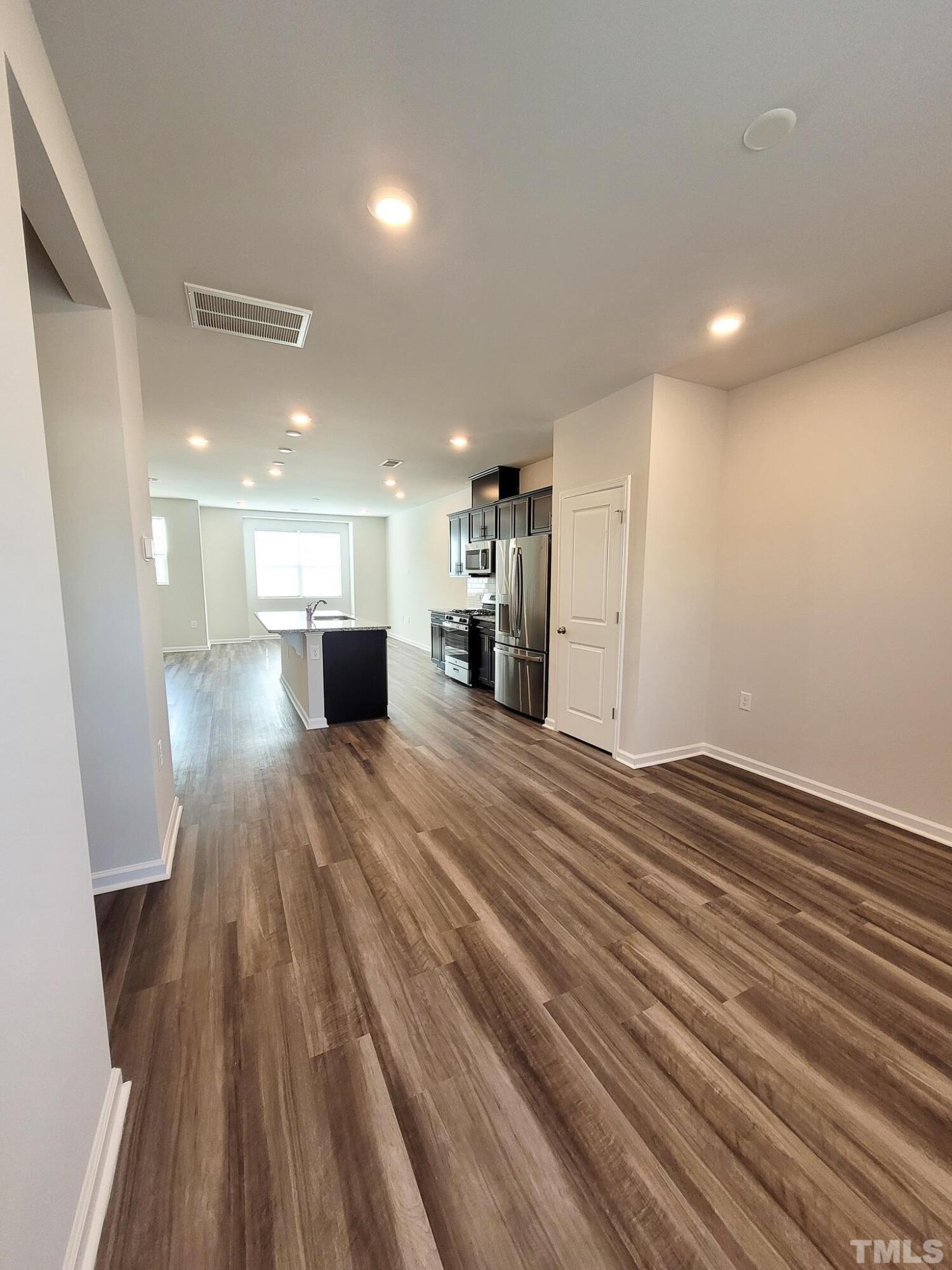 1038 Shoreside Drive Durham, NC 27713 - Photo 9 of 42 a view of empty room with wooden floor