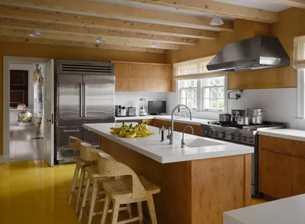 a kitchen with stainless steel appliances granite countertop a sink a stove and a refrigerator