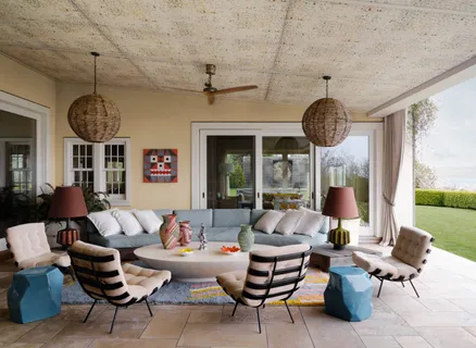 a living room with furniture chandelier and a large window