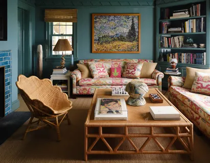a living room with furniture a rug and a bookshelf