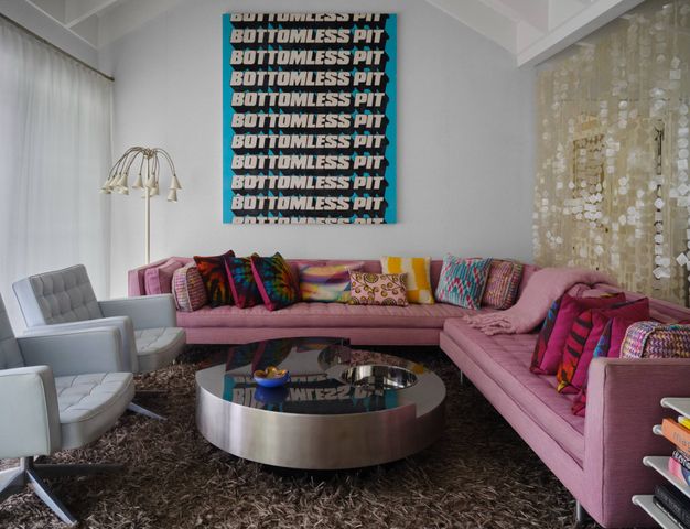 a living room with a couch and a potted plant