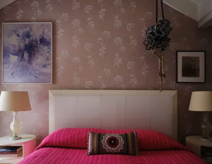 a bedroom with a bed and a potted plant