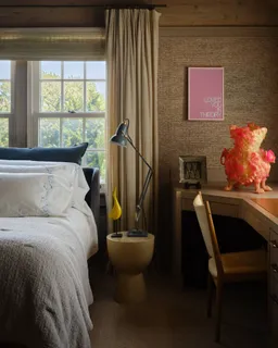 a bed sitting in a bedroom next to a window