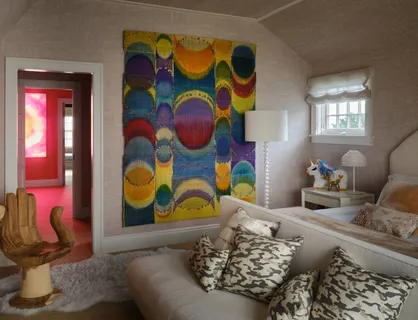 a living room with furniture and painting on the wall