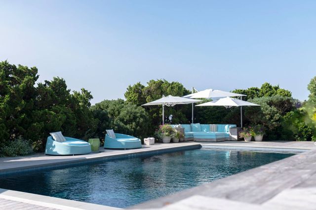 swimming pool view with a seating space