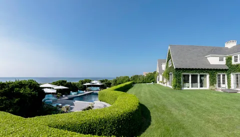 a view of a house with yard and furniture