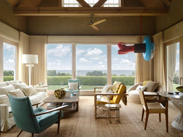 a living room with furniture and floor to ceiling windows