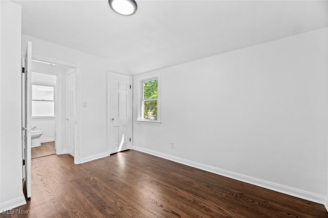 7719 Ackley Road Parma, OH 44129 - Photo 27 of 35 Unfurnished bedroom featuring dark wood-style flooring and ensuite bathroom