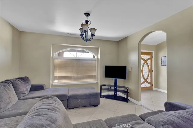 a living room with furniture a couch and a flat screen tv