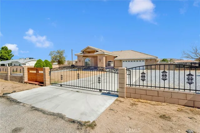 a view of a house with a wooden fence