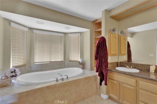 a bathroom with a granite countertop sink a mirror a and a shower