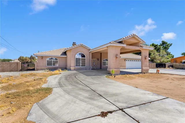 a view of a house with a yard and garage