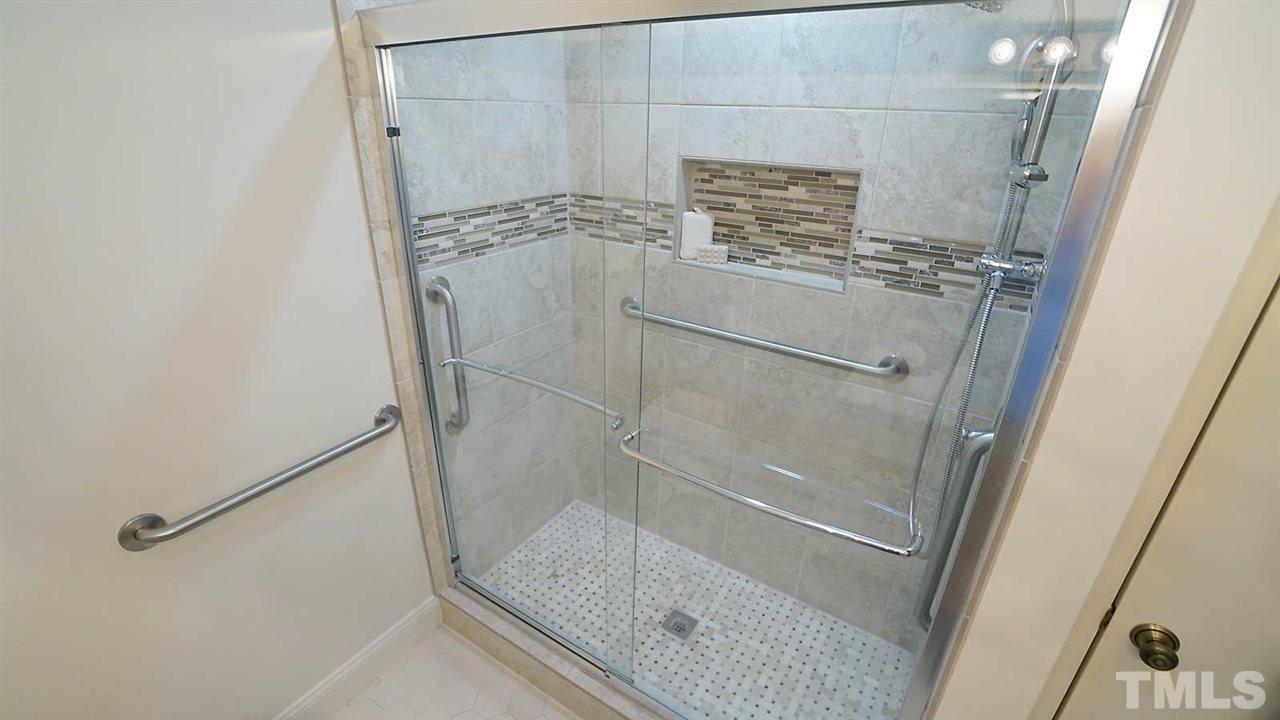 2801 Rue Sans Famille Raleigh, NC 27607 - Photo 15 of 26 Updgraded ceramic tile , walk-in shower with several hand rails for extra stability and safety