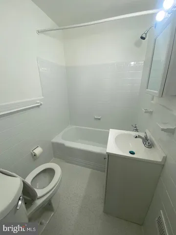 a bathroom with a sink a toilet and a bathtub