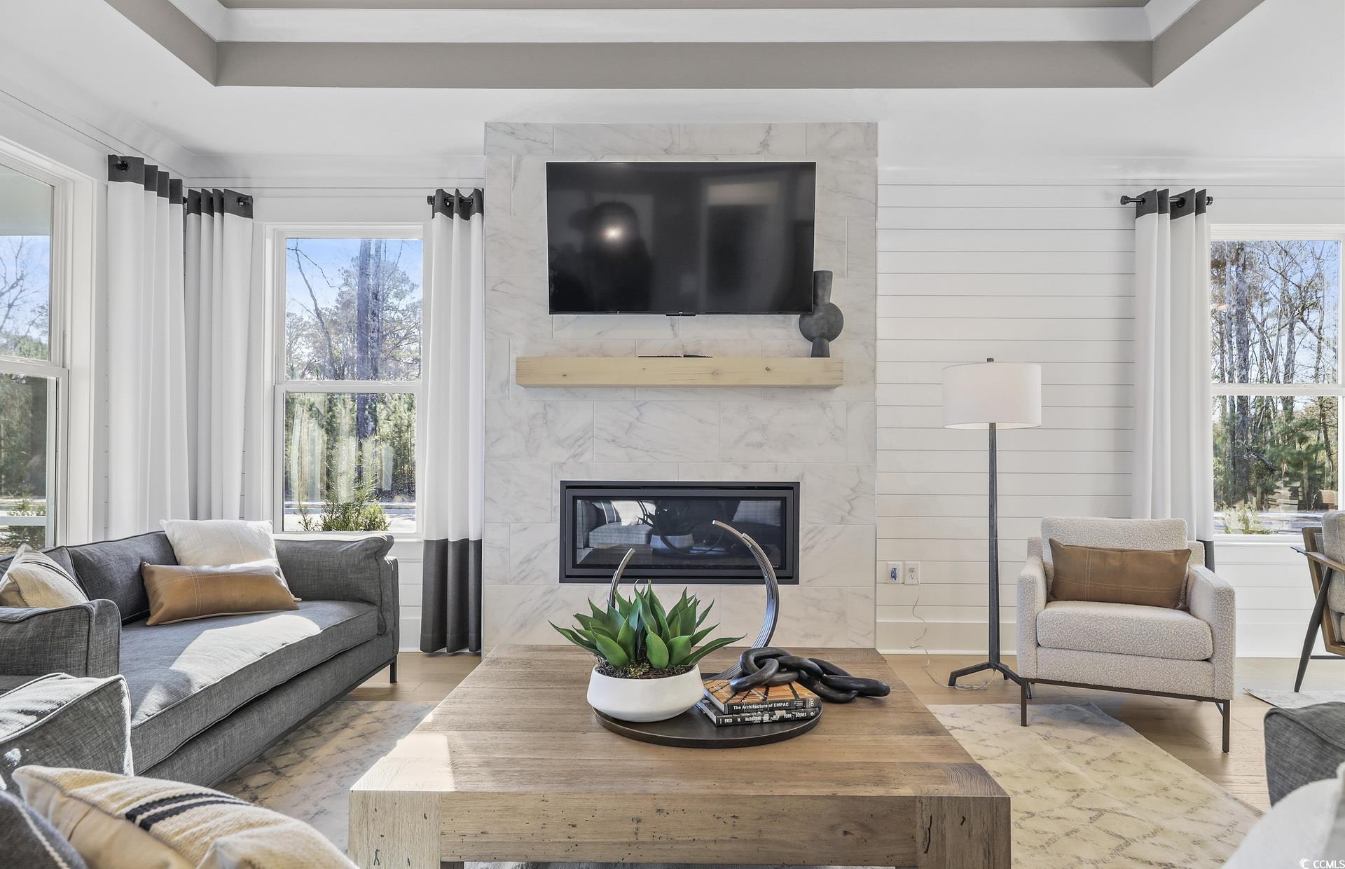 1514 Winding Crk Way Myrtle Beach, SC 29588 - Photo 7 of 20 Living room with a high end fireplace, healthy amount of natural light, and a tray ceiling