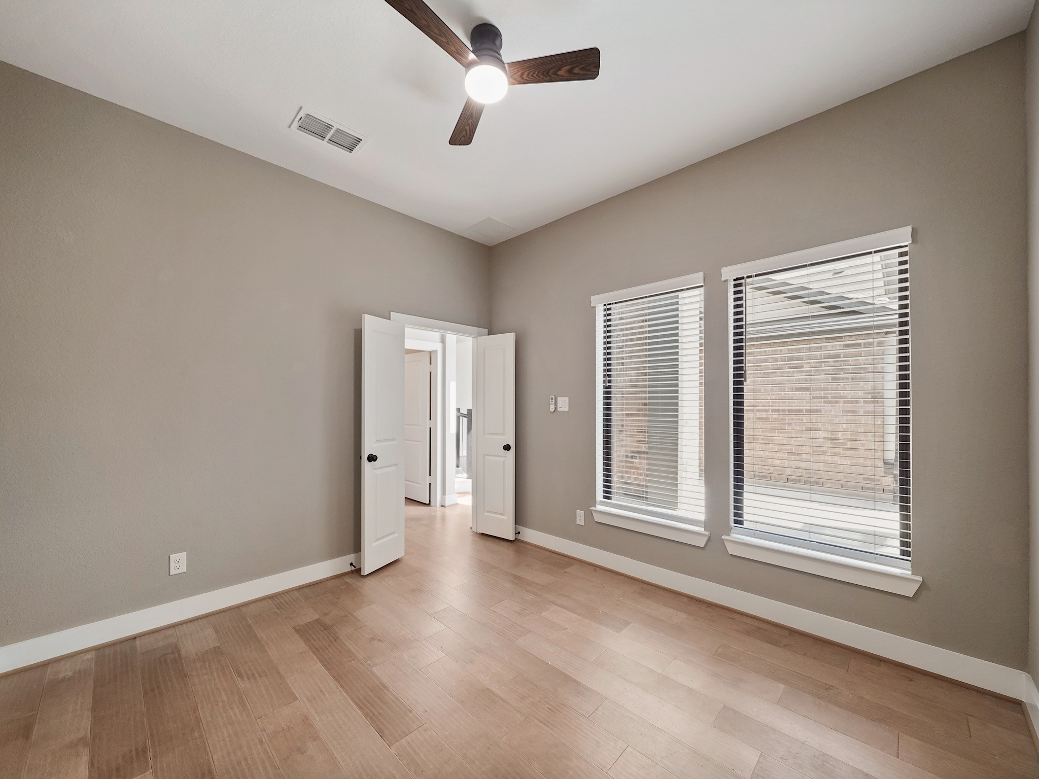 30214 Crossfield Road Fulshear, TX 77441 - Photo 5 of 42 A private study at the front of the home provides a composed workspace separated from the main living areas.