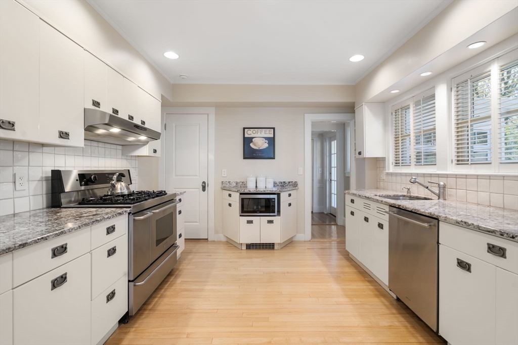 41 Nobscot Road Newton, MA 02459 - Photo 11 of 37 a kitchen with stainless steel appliances granite countertop a stove and a sink