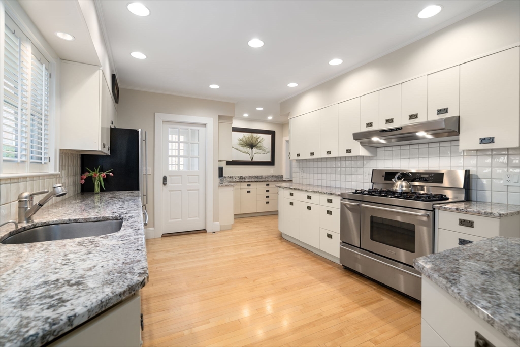 41 Nobscot Road Newton, MA 02459 - Photo 12 of 37 a kitchen with stainless steel appliances granite countertop a sink a stove and a refrigerator