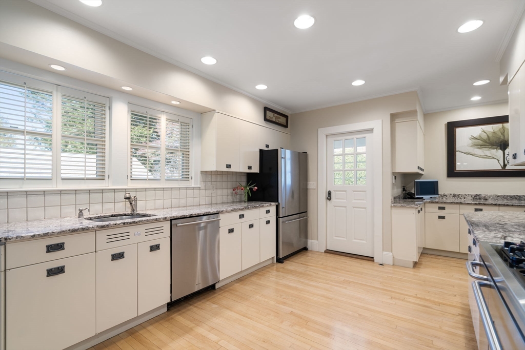 41 Nobscot Road Newton, MA 02459 - Photo 13 of 37 a large kitchen with stainless steel appliances granite countertop a sink and cabinets with wooden floor