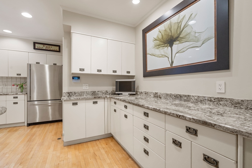 41 Nobscot Road Newton, MA 02459 - Photo 14 of 37 a kitchen with stainless steel appliances granite countertop a refrigerator and a stove top oven