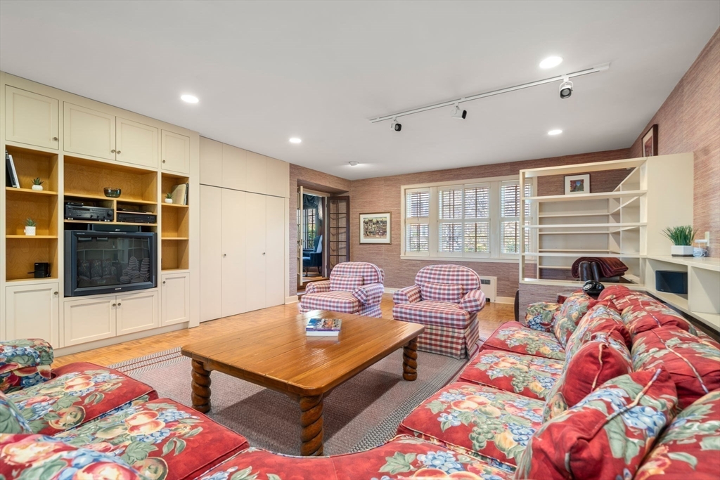 41 Nobscot Road Newton, MA 02459 - Photo 16 of 37 a living room with furniture a flat screen tv and kitchen view