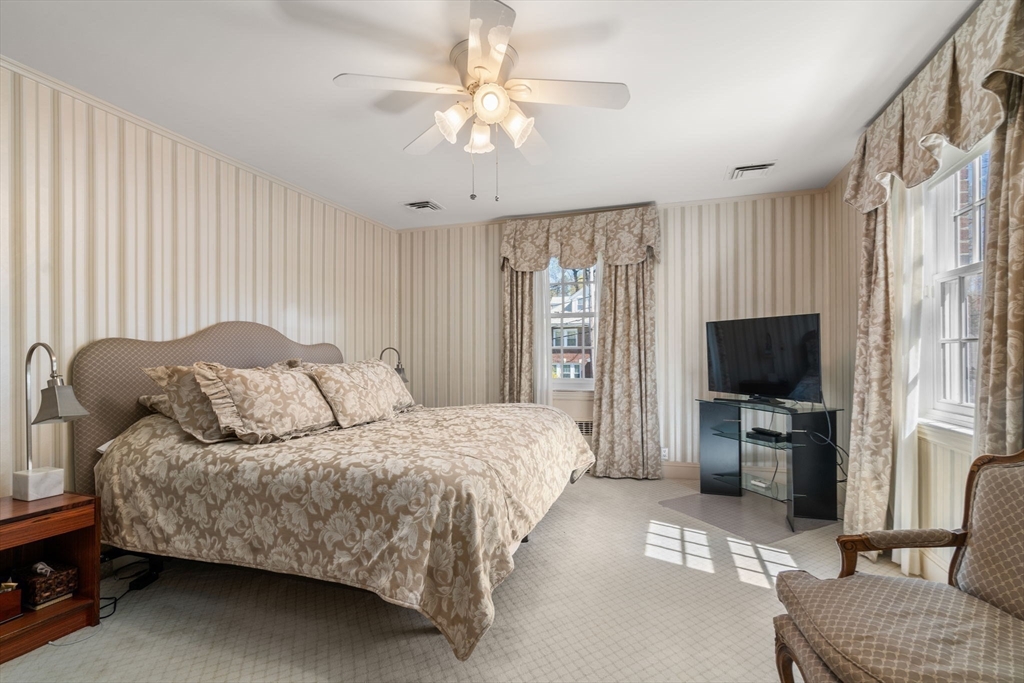 41 Nobscot Road Newton, MA 02459 - Photo 23 of 37 a bedroom with a bed flat screen tv and a couch