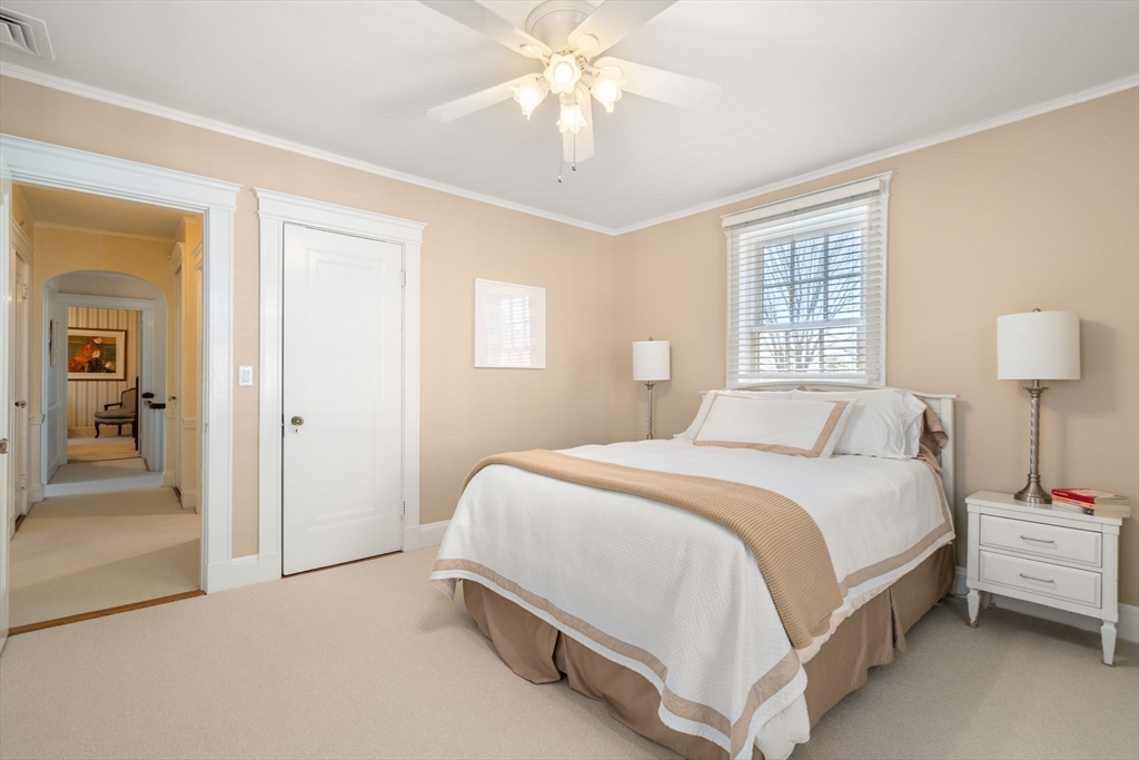 41 Nobscot Road Newton, MA 02459 - Photo 28 of 37 a bedroom with a bed and a chandelier