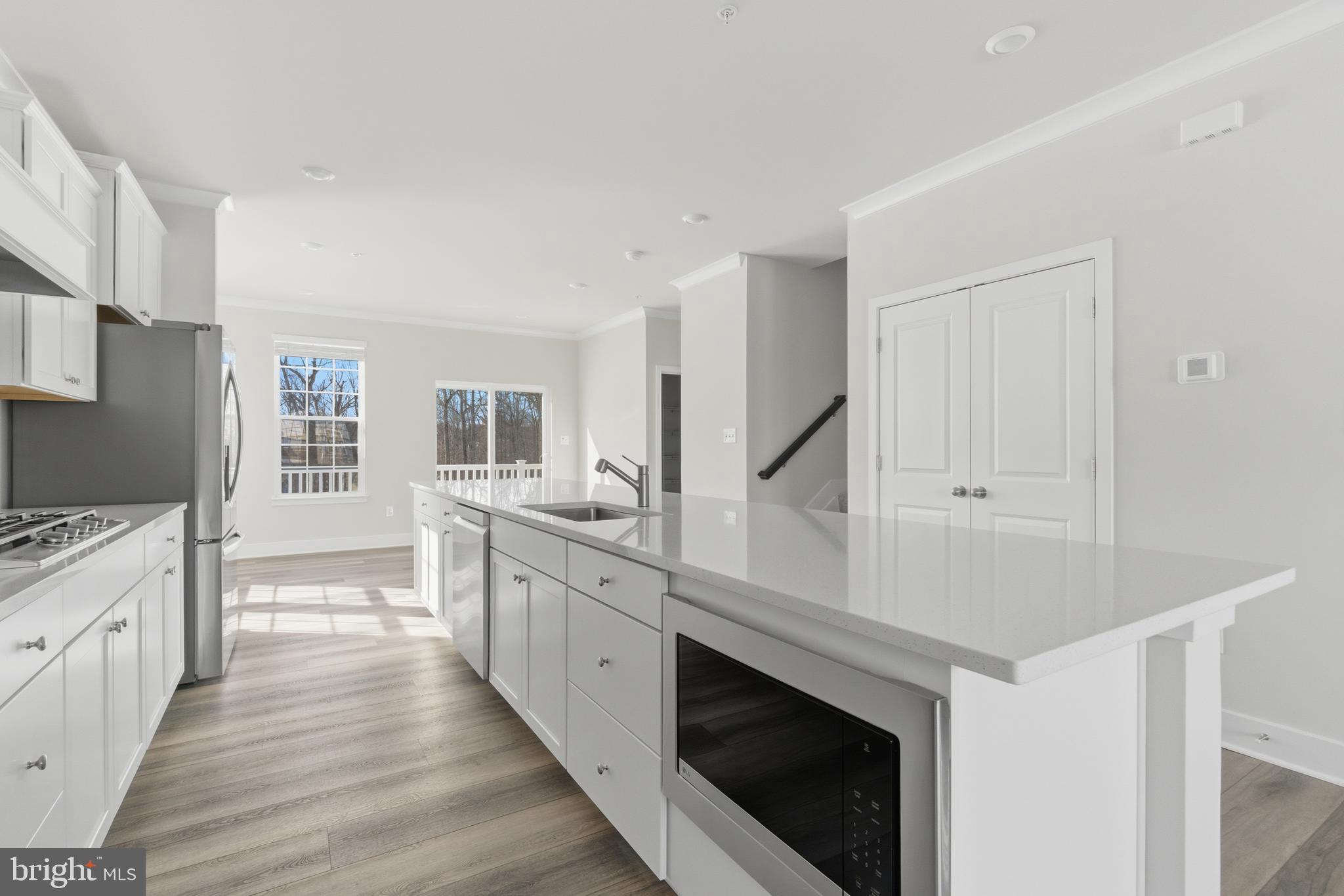 1722 Water Xing Road Baltimore, MD 21208 - Photo 11 of 41 a large kitchen with cabinets wooden floor and stainless steel appliances