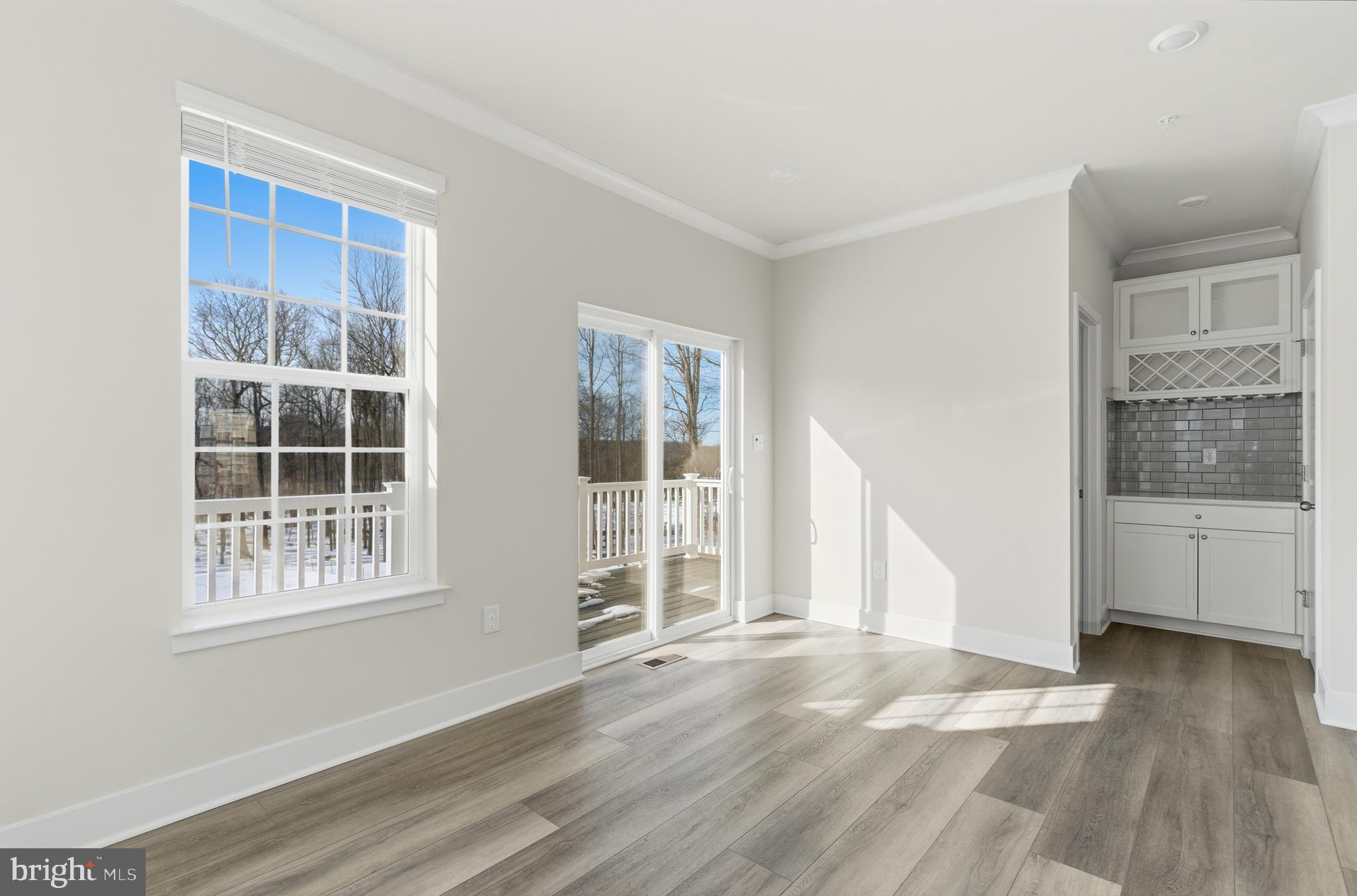 1722 Water Xing Road Baltimore, MD 21208 - Photo 16 of 41 a view of an empty room with a window and wooden floor