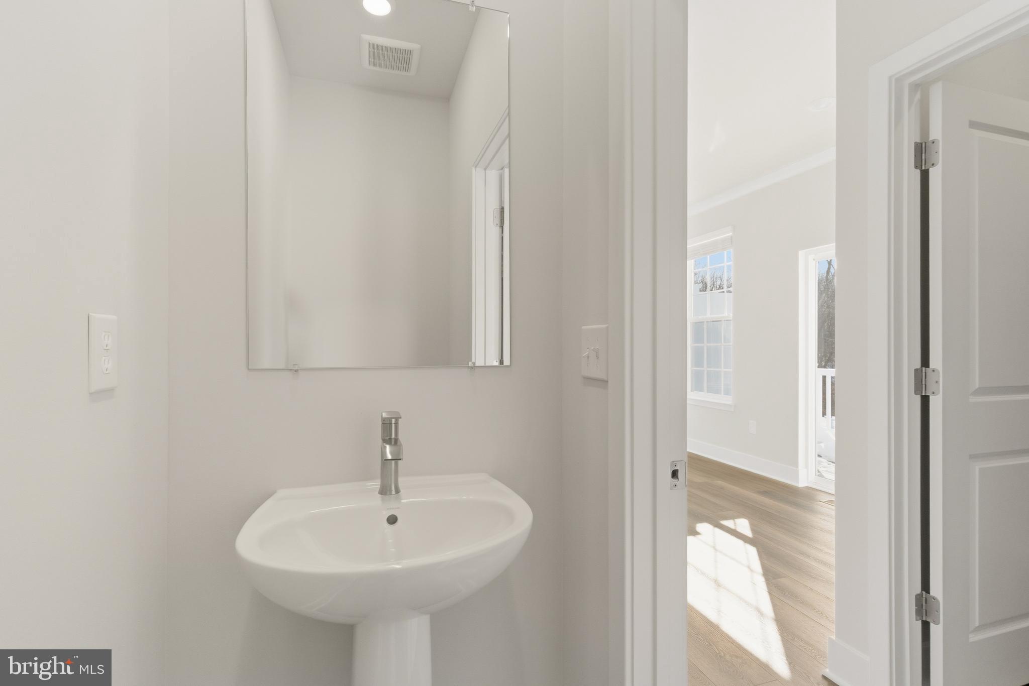 1722 Water Xing Road Baltimore, MD 21208 - Photo 17 of 41 a bathroom with a sink and a mirror