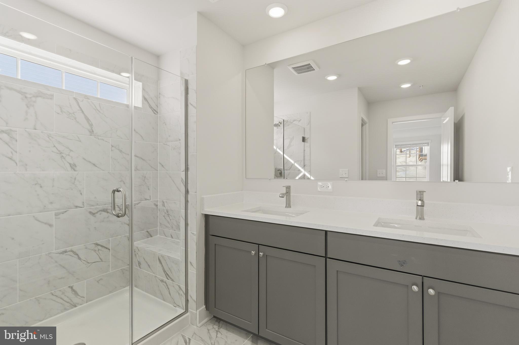 1722 Water Xing Road Baltimore, MD 21208 - Photo 24 of 41 a bathroom with a double vanity sink and mirror