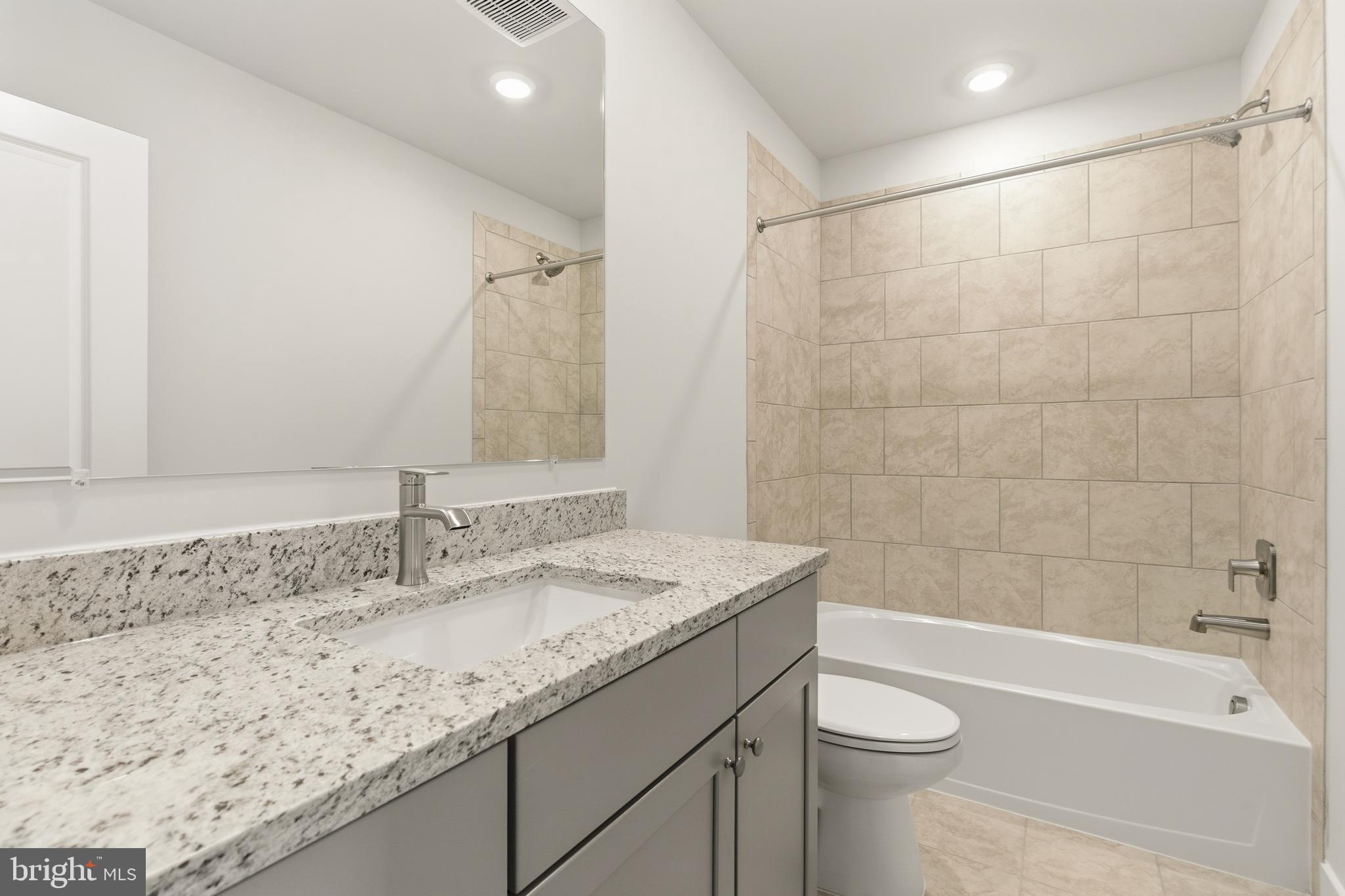 1722 Water Xing Road Baltimore, MD 21208 - Photo 27 of 41 a bathroom with a granite countertop sink a toilet and bathtub